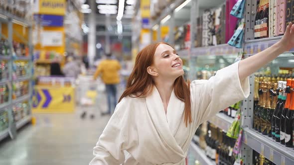 Goodlooking Young Woman Buying Alcohol in the Store
