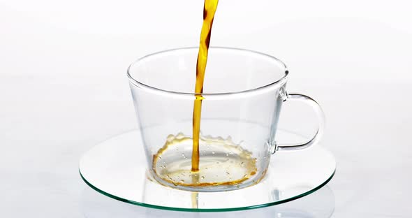 900154 Coffee beans Falling in a Cup against White Background, Slow motion alt