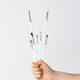 Hand holding white paintbrushes - PhotoDune Item for Sale