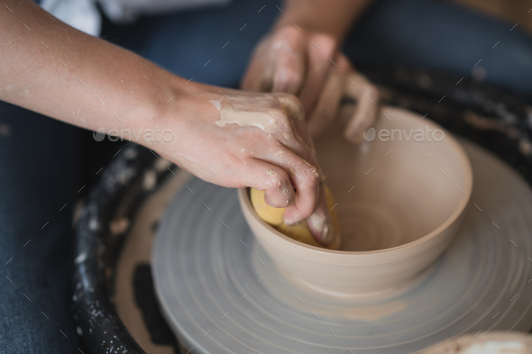 Potter makes on pottery wheel clay pot., Stock image