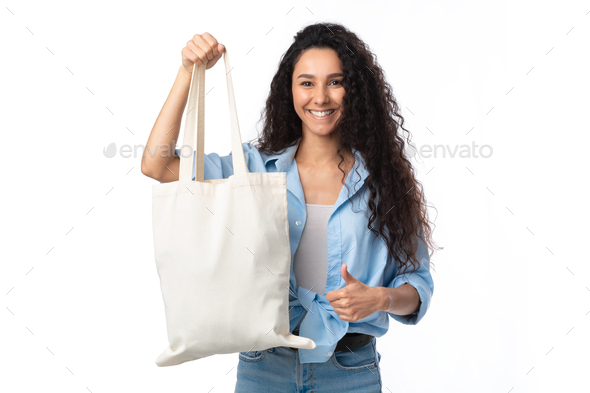 Lady Showing White Eco Shopper Bag Gesturing Thumbs-Up, White Background