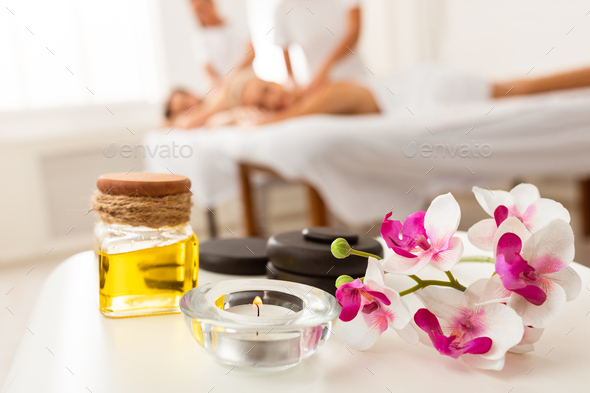 Couples Massage Spa Composition With Stones, Oil And Orchid Flowers