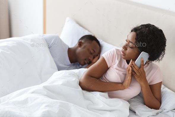 Woman cheating on her boyfriend, talking with lover on phone Stock Photo by Prostock-studio