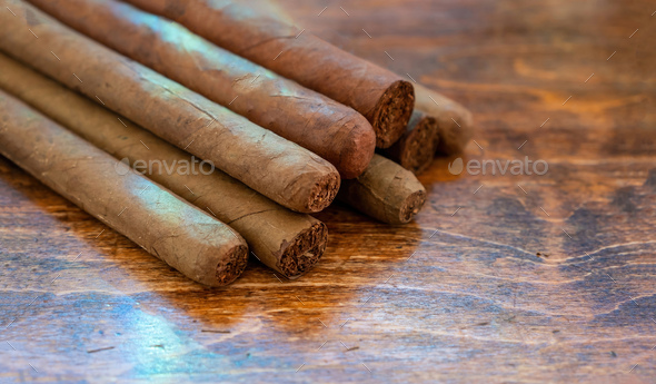 Cuban cigars variety on wooden office desk, closeup view
