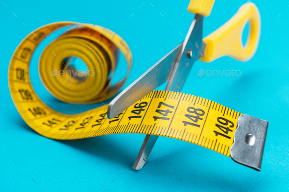 Scissors Cutting Yellow Measuring Tape Dieting Concept
