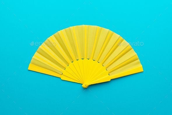 Download Top View Of Opened Yellow Hand Fan On Turquoise Blue Background With Copy Space Stock Photo By Garloon