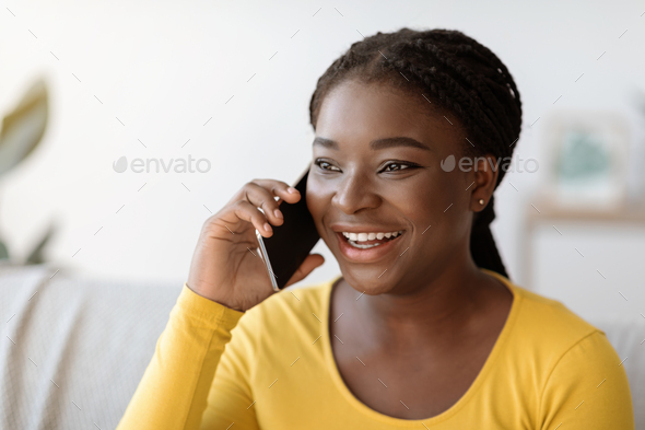 Cheerful black woman speaking on phone · Free Stock Photo