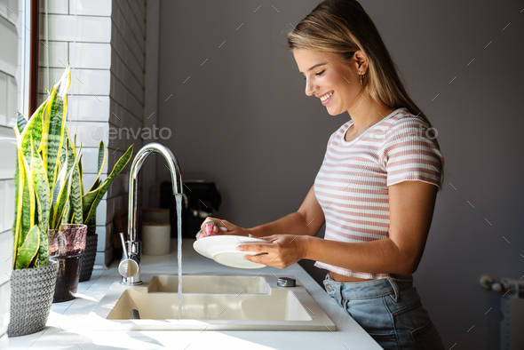 Dishwashing Happy Young Woman Washing Dishes Stock Photo, Picture and  Royalty Free Image. Image 14193419.
