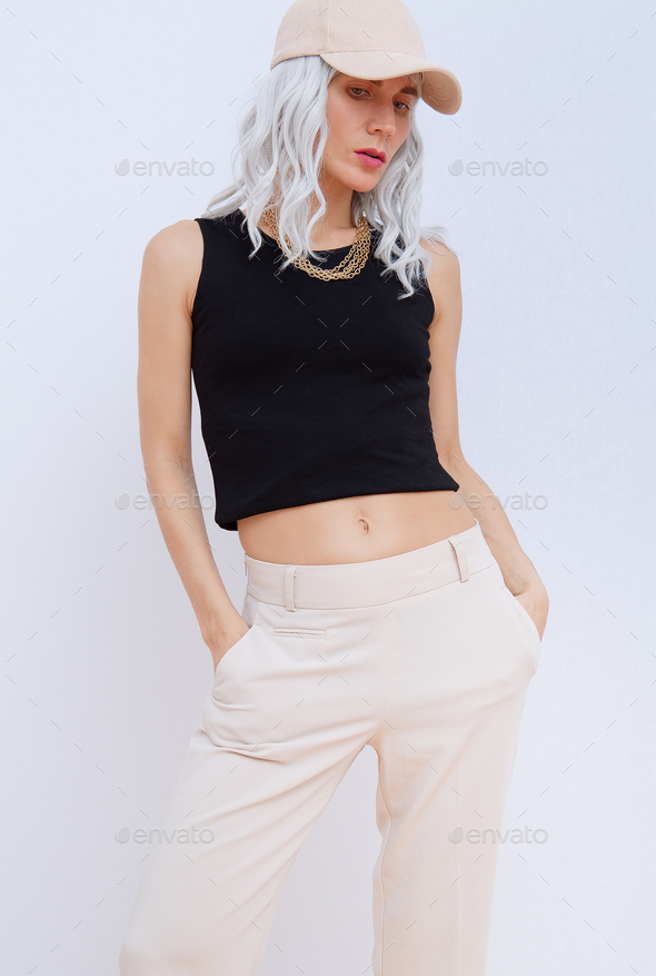 Transgender Woman fashion portrait in stylish beige casual lookbook. Spring  summer outfit concept Stock Photo by EvgeniyaPorechenskaya