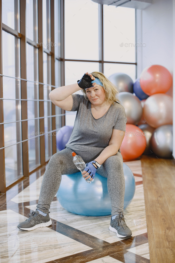 Adult fat woman have a rest at the gym