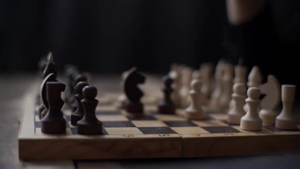 Closeup Tracking Shot of Unrecognizable Chess Player Performing Move with Pawn Piece on Chessboard alt