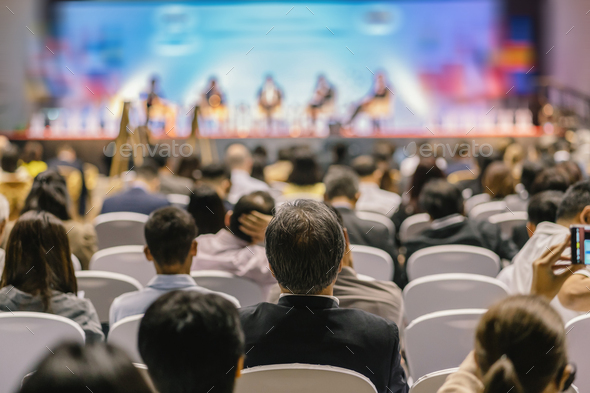 Rear view of Audience listening Speakers on the stage in the conference hall or seminar meeting - Stock Photo - Images