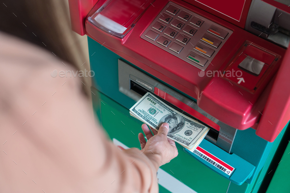 Top view of Closeup woman withdrawing the cash via ATM, business Automatic Teller Machine concept