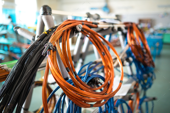 Coil of copper wire hangs on an iron rack