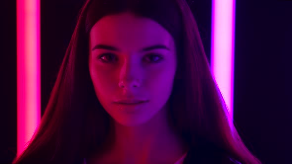 Portrait of a Pretty Young Beautiful Woman Coquettishly Looking at the Camera. Face Close Up. Slow alt