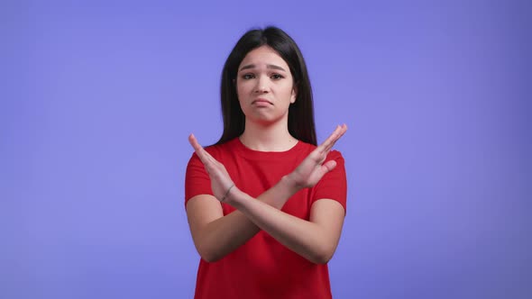 Pretty Girl Disapproving with No Crossing Hands Sign Make Basta Negation Enough Gesture alt