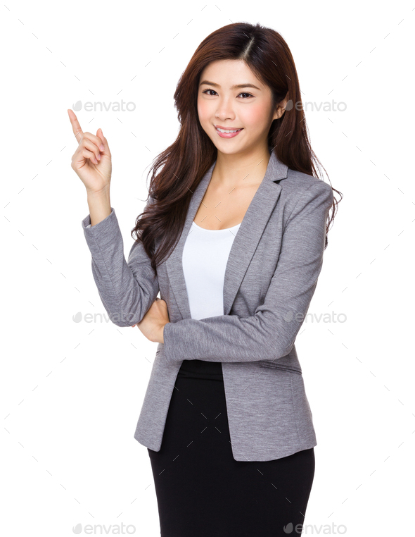 Young asian business woman pointing on copy space Stock Photo by leungchopan