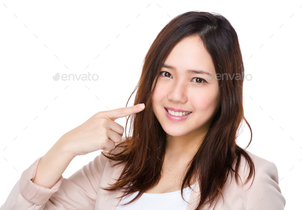 Asian businesswoman with finger point to her teeth