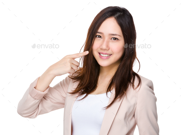 Businesswoman finger point to her teeth