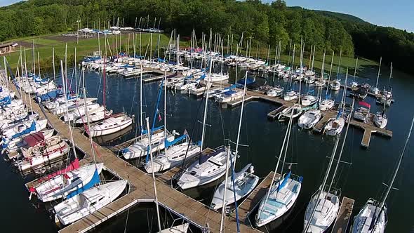 Aerial footage of sailboat marina. alt