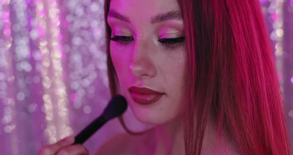 Glamour Girl with Perfect Makeup in Pink Light alt