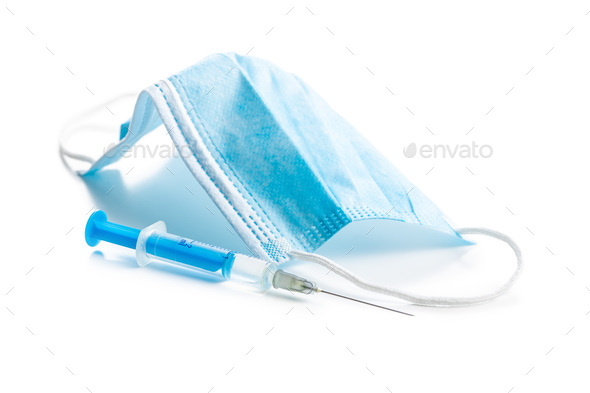 Injection syringe and protection face mask. Covid-19 coronavirus vaccination. Corona virus vaccine