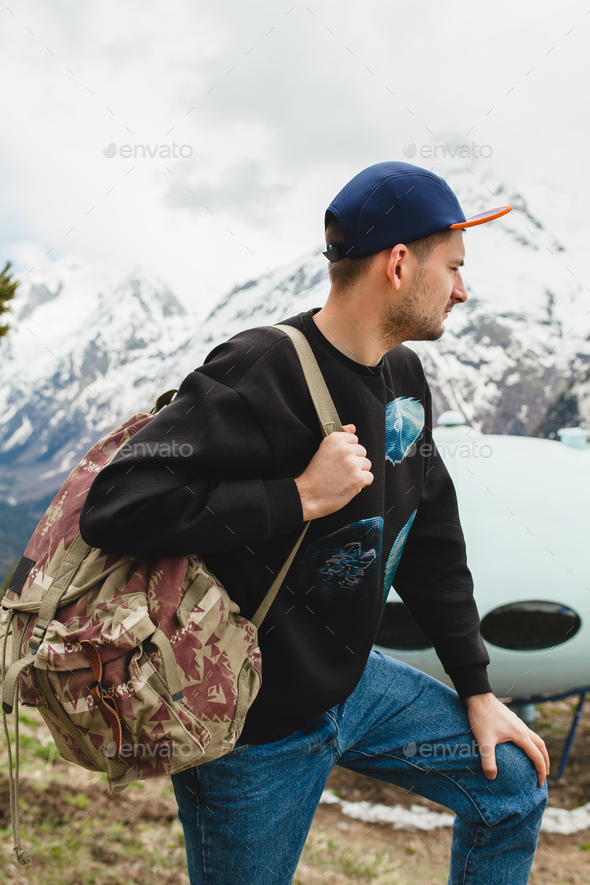 young hipster woman walking in mountains, swag outfit, winter