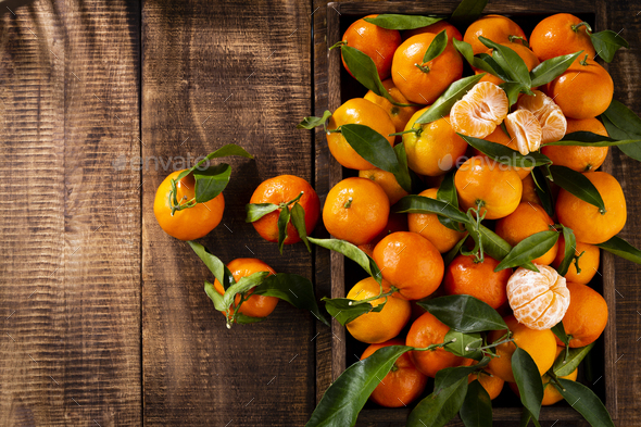 Premium Photo  Fresh mandarin oranges fruit or tangerines with leaves in  wooden box, top view