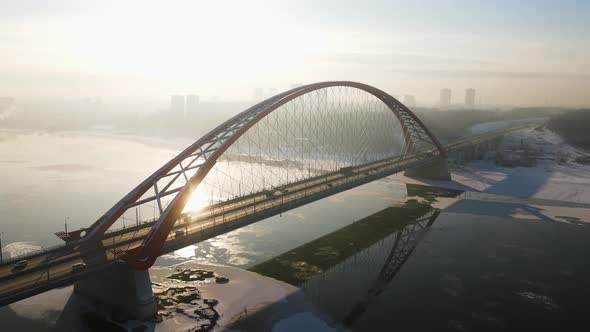 Bugrinsky Bridge Against the Backdrop of the Setting Sun and Light Haze alt