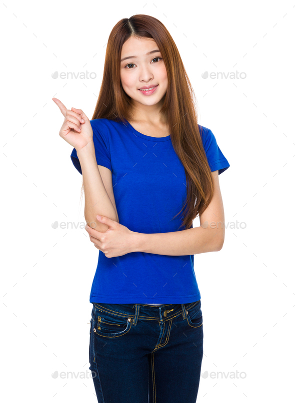 Asian woman pointing to empty space - Stock Photo - Images