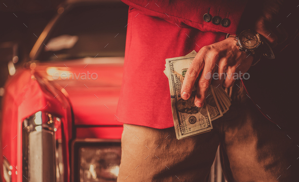Men with Pile of Cash Money in Front of His Classic Car