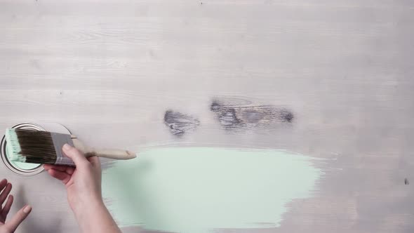 Home improvement project. Painting wood with turquoise color paint. alt