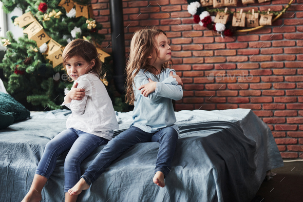 We don't talk. Offended at each other. Kids in the beautiful room at new year having some bad mood - Stock Photo - Images