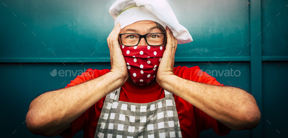 Shock and crazy expression scared man with chef hat and red medical protection mask - coronavirus