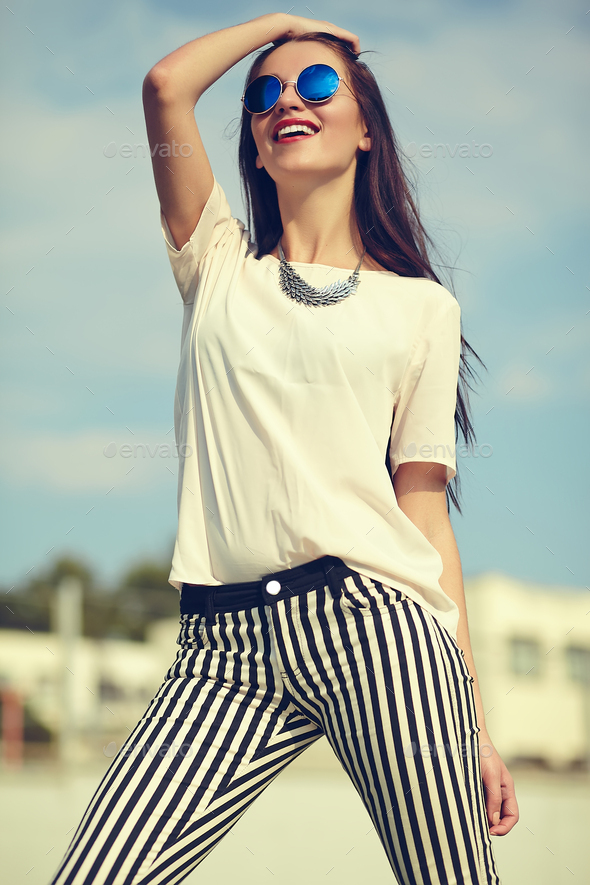 Portrait of young stylish woman posing outdoors - Stock Photo - Images