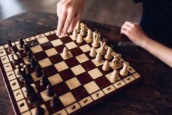 A boy plays chess at home during quarantine. Leisure, Hobbies.