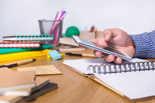 Young man sitting at the table and studying from home - Stock Photo - Images