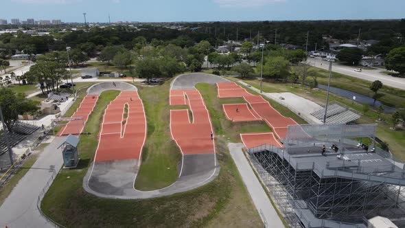BMX rider launches into the air after a big jump from the launch ramp alt
