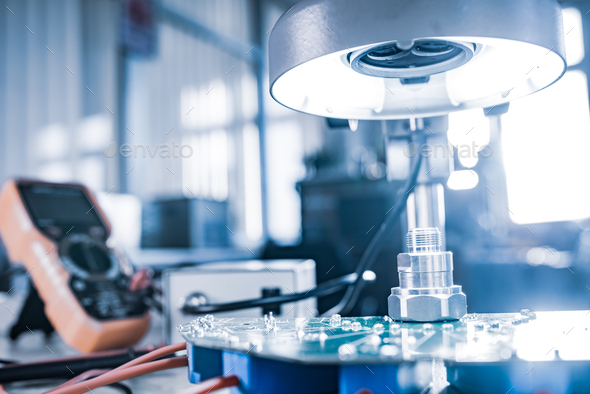 Modern microscope, connectors component and large green microcircuit in ...