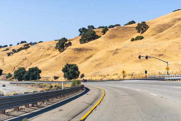 Freeway crossing the golden hills of Alameda County - Stock Photo - Images