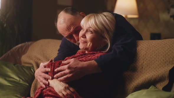 Elderly Man Hugging His Wife alt