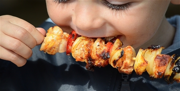 Boy Eating Grilled Meat