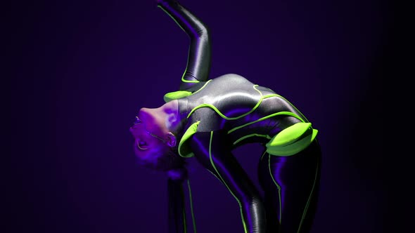 Flexible Slim Woman Bending Back Raising Leg Standing on Cube in Ultraviolet Light alt