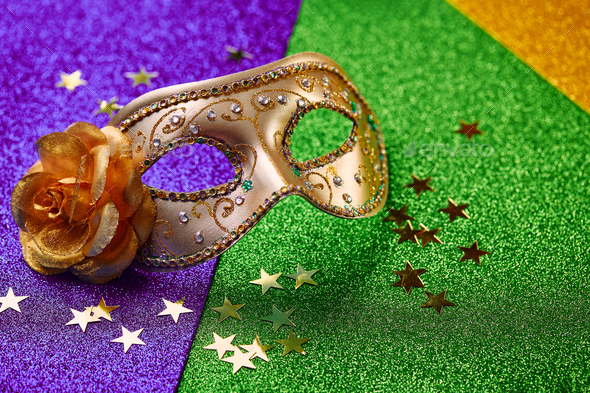 Festive, colorful Mardi Gras or carnivale mask on golden background.  Venetian masks Stock Photo by Irrin