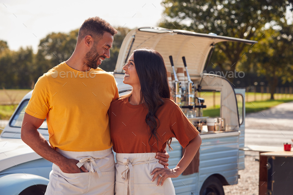 Couple Running Independent Mobile Coffee Shop Standing Outdoors Next To Van