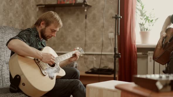 Adult Men Playing Guitars at Home