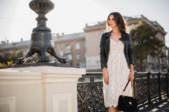 attractive woman walking in street in fashionable outfit Stock