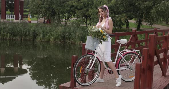 Beautiful Girl with Kanekalons Smelling the Flowers