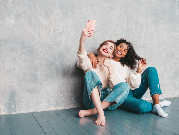 Fashion portrait of two young beautiful women. - Stock