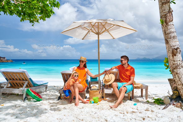 Family with three year old boy on beach. Seychelles, Mahe. - Stock Photo - Images